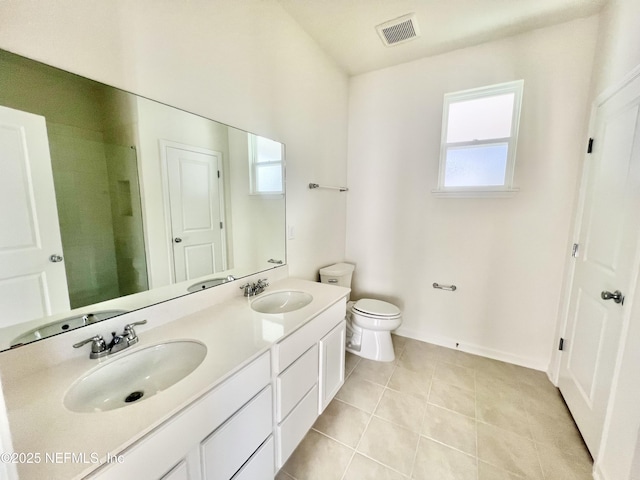 bathroom with a shower, tile patterned floors, vanity, and toilet