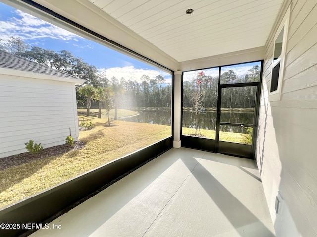 unfurnished sunroom with a water view