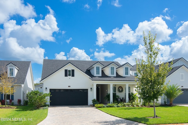 cape cod house featuring a porch, a garage, and a front yard