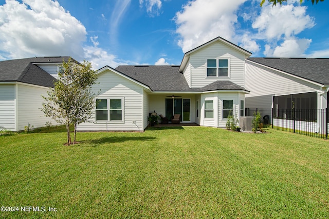 back of house with a lawn and a patio