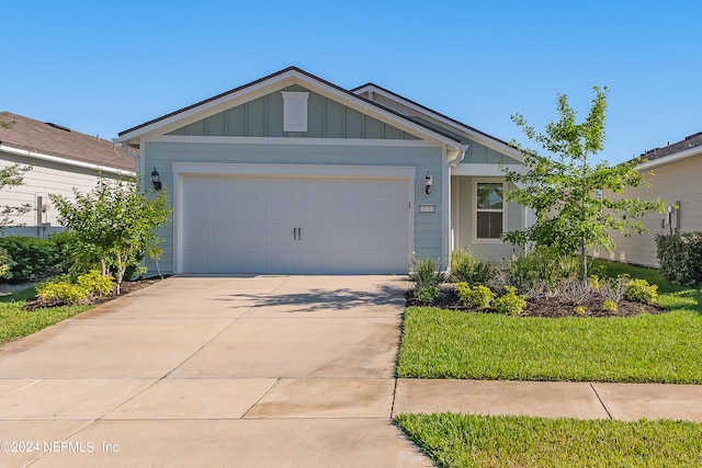 view of front facade with a garage and a front lawn