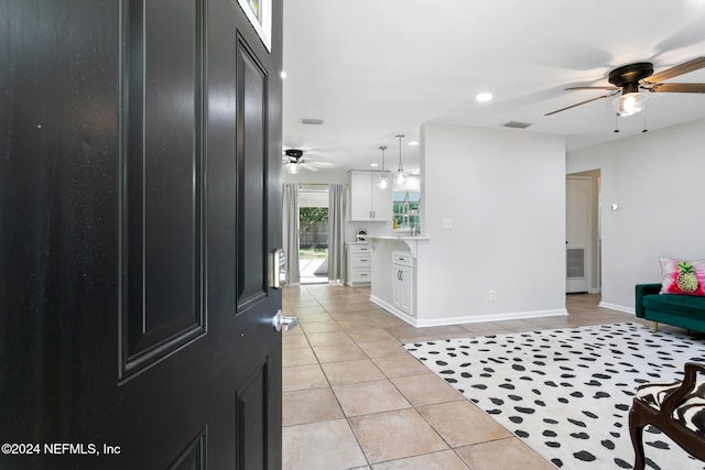 tiled foyer entrance featuring ceiling fan