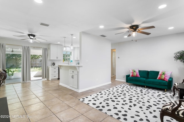 living room with ceiling fan and light tile patterned floors