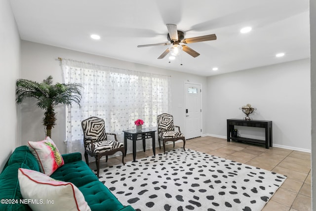 living area featuring light tile patterned floors and ceiling fan