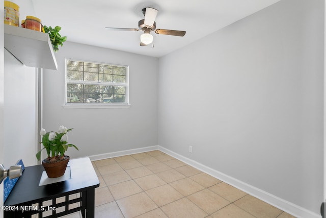 empty room featuring light tile patterned flooring and ceiling fan