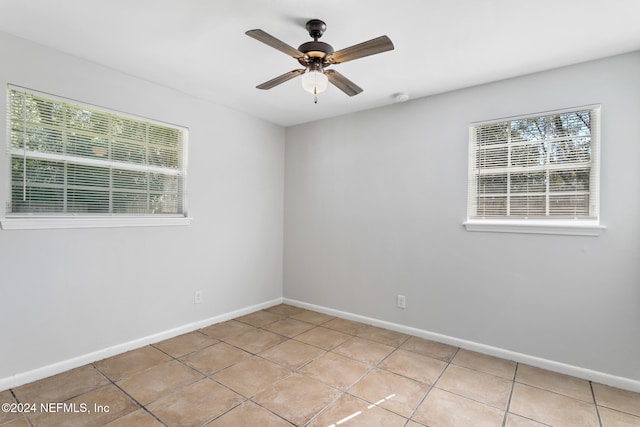 spare room featuring light tile patterned floors and ceiling fan