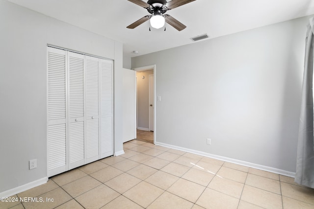 unfurnished bedroom featuring a closet, ceiling fan, and light tile patterned flooring