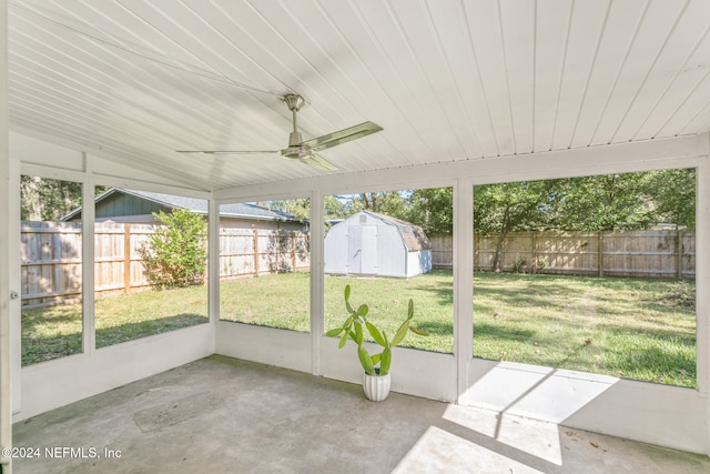 unfurnished sunroom featuring ceiling fan and vaulted ceiling