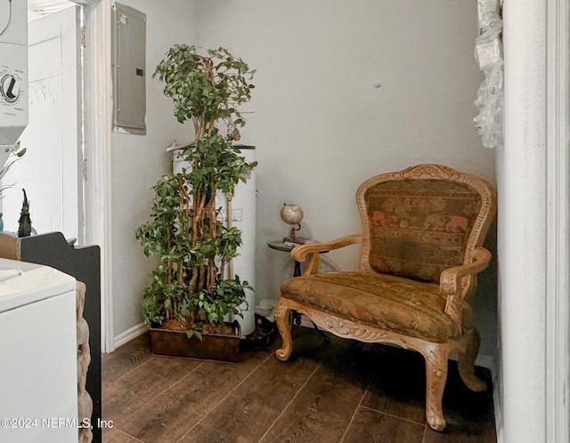 living area with dark wood-type flooring and electric panel