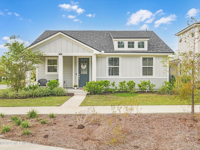 view of front of home with a front yard and a porch