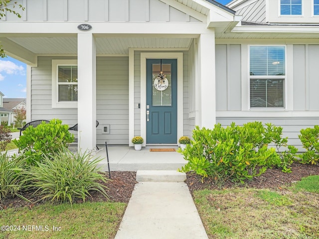 doorway to property featuring covered porch