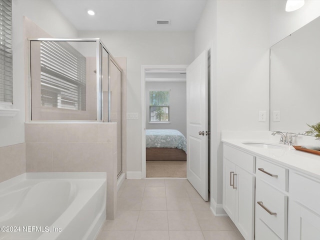 bathroom featuring vanity, independent shower and bath, and tile patterned floors