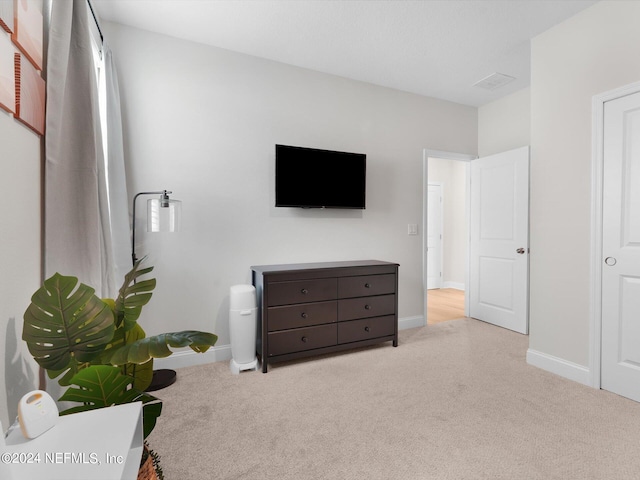 bedroom featuring light colored carpet