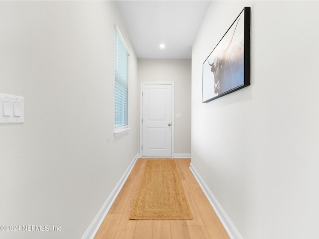 hall with hardwood / wood-style flooring