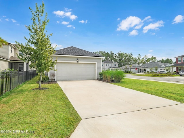 view of front of house with a front yard and a garage