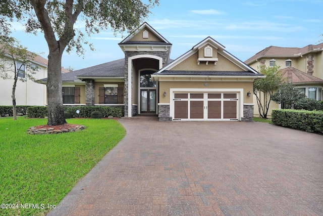 view of front of home with a front yard and a garage