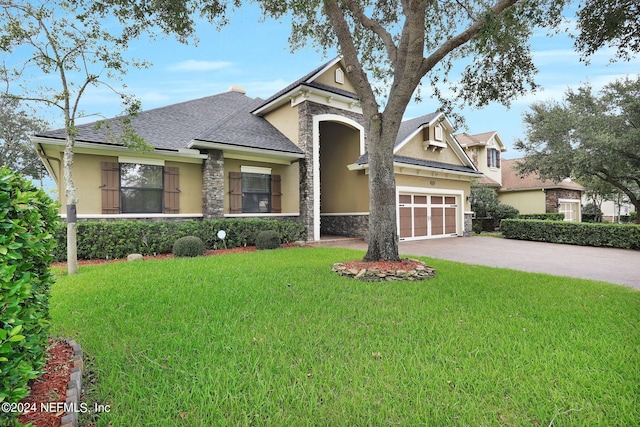 view of front of property with a front yard and a garage