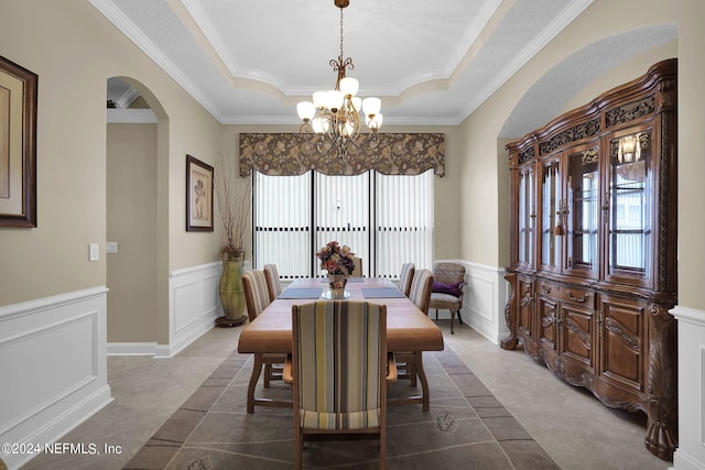 dining area featuring ornamental molding, a tray ceiling, and plenty of natural light