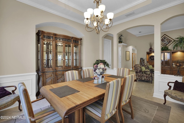 dining space featuring crown molding and an inviting chandelier