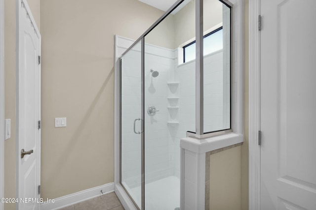 bathroom featuring an enclosed shower and tile patterned floors