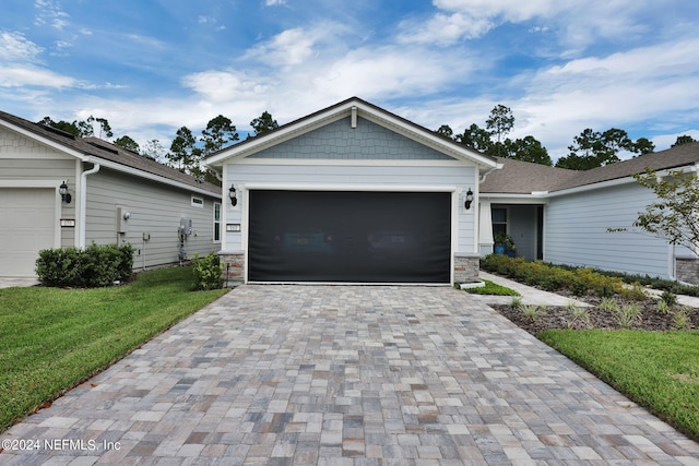 view of front of house with a front lawn and a garage