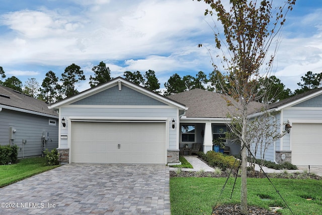 view of front of house featuring a front yard and a garage