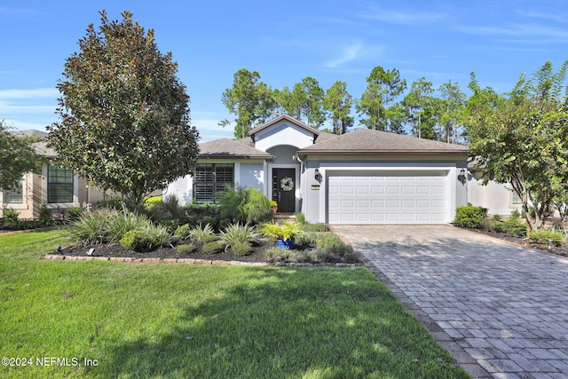 view of front of home featuring a front lawn and a garage