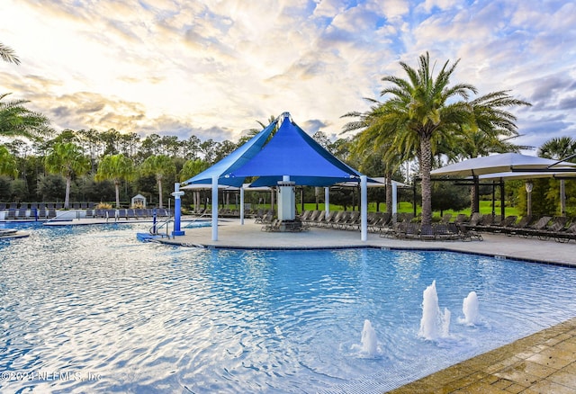 view of pool featuring a gazebo, pool water feature, and a patio area