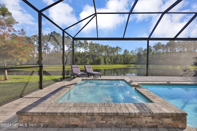 view of swimming pool featuring a lanai, a water view, and a patio area