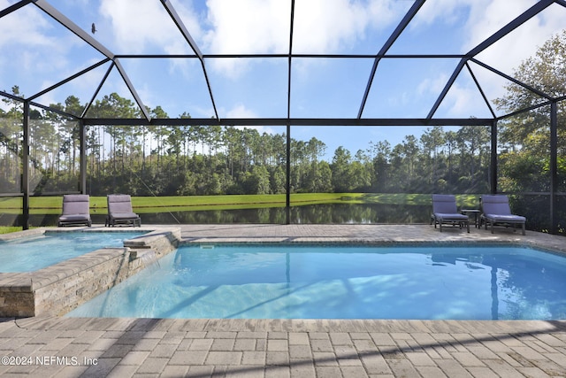 view of pool featuring glass enclosure, a water view, an in ground hot tub, and a patio area