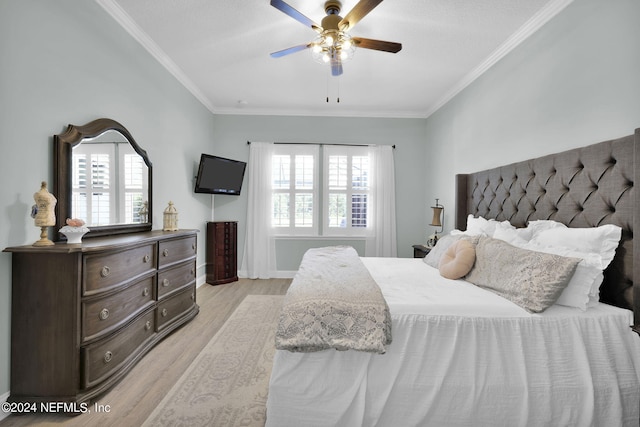 bedroom featuring multiple windows, light hardwood / wood-style floors, ornamental molding, and ceiling fan