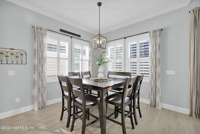 dining space featuring an inviting chandelier and light hardwood / wood-style floors