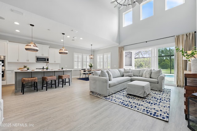 79 Shadow Ridge Trl, Ponte Vedra, FL 32081 - living room with recessed lighting, light wood-style floors, a wealth of natural light, and ornamental molding