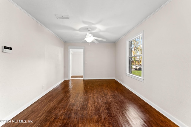 spare room with ceiling fan, ornamental molding, and dark wood-type flooring