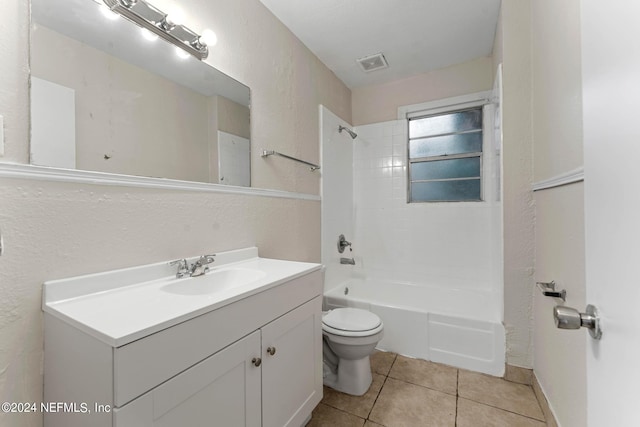 full bathroom featuring tile patterned flooring, tiled shower / bath, vanity, and toilet