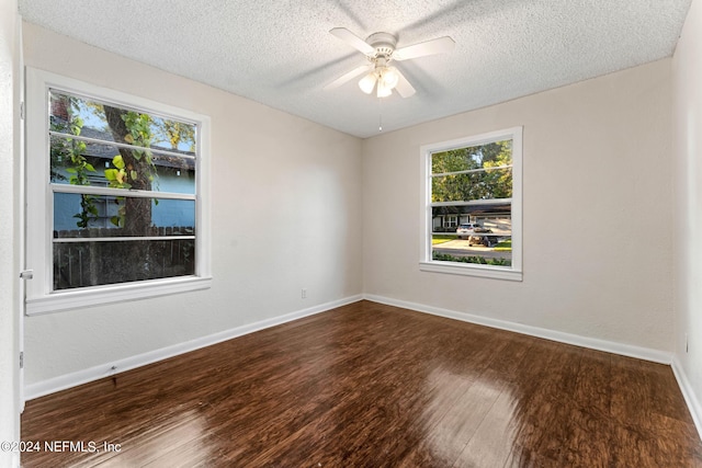 spare room featuring ceiling fan, a textured ceiling, and dark wood-type flooring