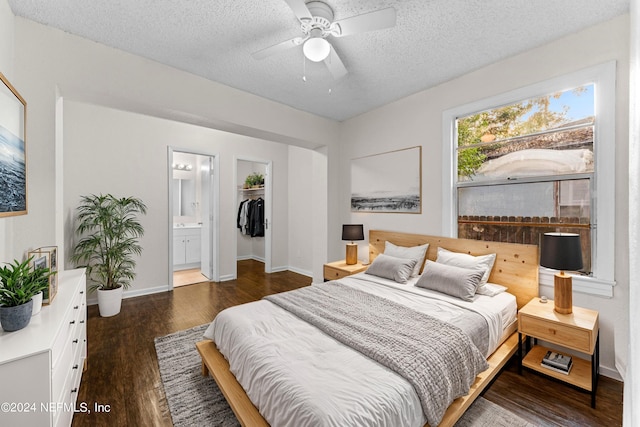 bedroom featuring a closet, a textured ceiling, dark hardwood / wood-style floors, ensuite bathroom, and ceiling fan