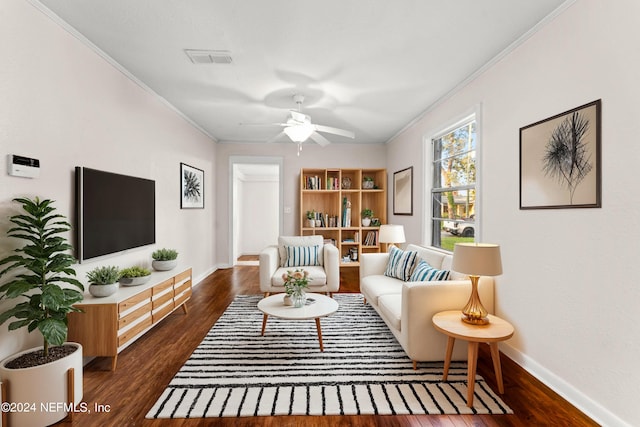 living room with crown molding, dark hardwood / wood-style floors, and ceiling fan