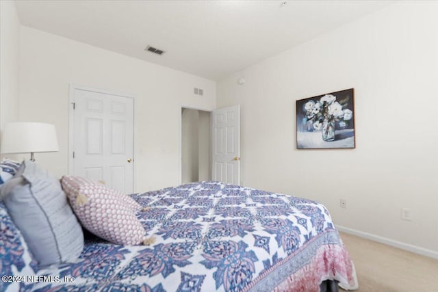 bedroom with carpet and a closet