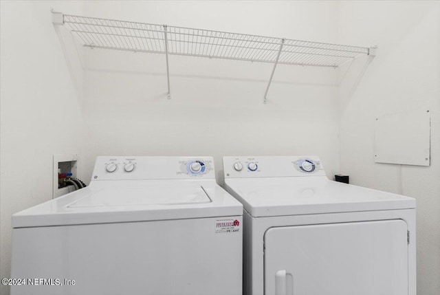 clothes washing area featuring washing machine and dryer