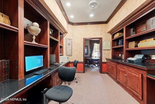 office featuring light colored carpet, crown molding, and built in desk