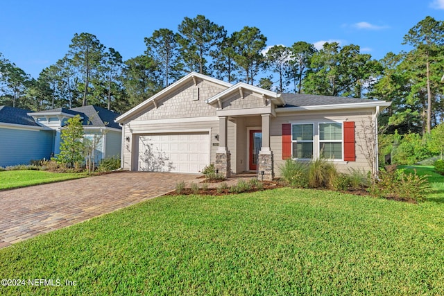 craftsman-style house with a garage and a front lawn