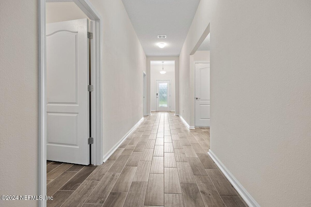 corridor with wood-type flooring