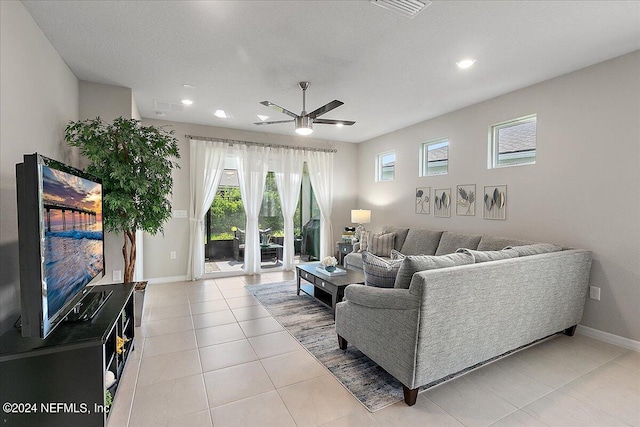 living room featuring ceiling fan and light tile patterned floors