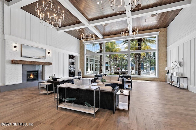 living room featuring wood-type flooring, beamed ceiling, and a high ceiling