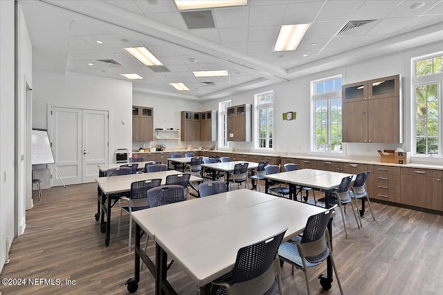 dining area featuring a drop ceiling and dark hardwood / wood-style floors