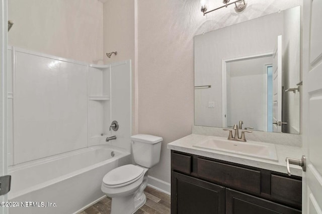 full bath featuring shower / bathing tub combination, toilet, vanity, wood finished floors, and baseboards