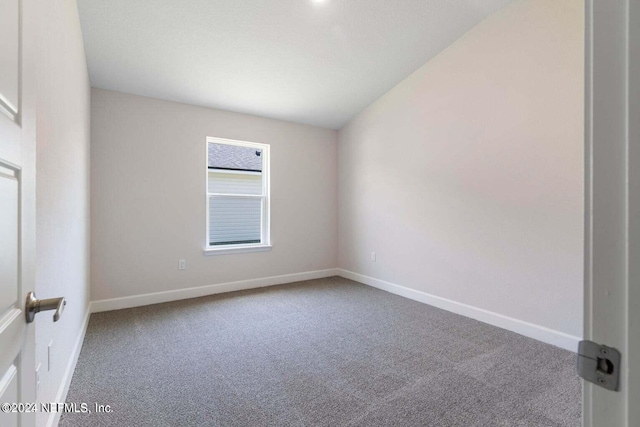 empty room featuring carpet floors and baseboards