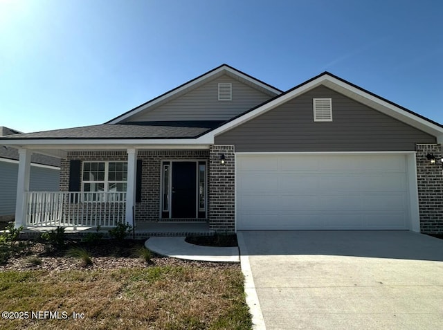 ranch-style house with brick siding, roof with shingles, covered porch, a garage, and driveway