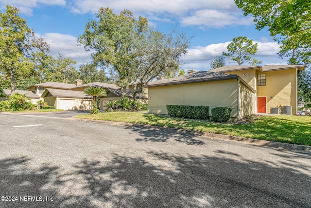 view of front of property with a front yard and a garage